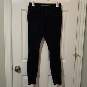 Distressed black skinny jeans
